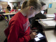 McLoughlin Middle School student Katie Johnson uses an iPad in Monica Hughey's sixth grade class.