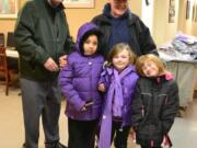 Esther Short: Harry Chaffee, left, and Jerry Andre of the Knights of Columbus passed along new coats to all the kids at Open House Ministries - like Ta'Nashia Jackson, 7, and sisters Madyson Oliver, 7, and Hailey Oliver, 5.