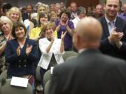 Clark County Administrator Bill Barron looks upon a crowd of over 100 as they applaud him Thursday for his 14 years of service to the county. Former Clark County Commissioner Betty Sue Morris, center in white, said hiring Barron was among her best decisions as a commissioner.