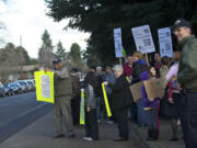 Norris Hibbler, left, shows a sign to a passing car as he and other community members show their support for Pearson Air Museum during a Thursday protest.