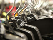 Laina Harris looks through the clothing racks at a department store Tuesday while shopping for a party dress to wear to a Christmas Eve party.