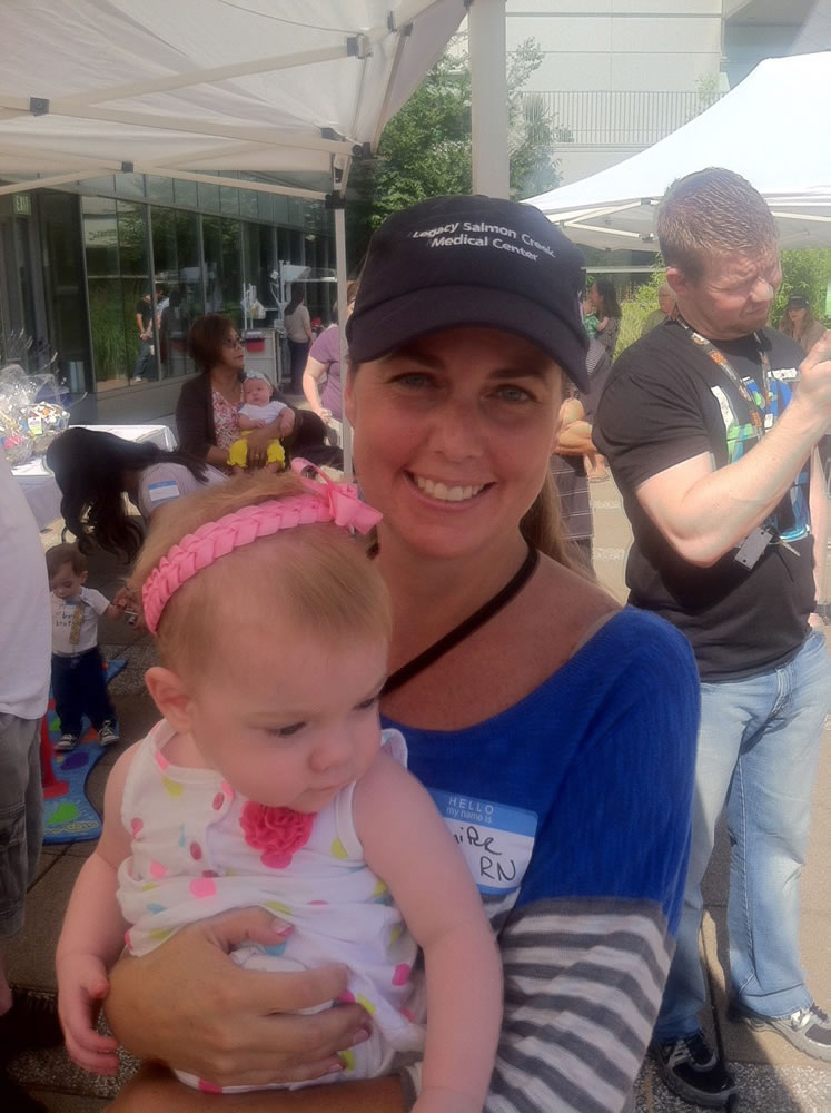 Salmon Creek: Registered Nurse Jennifer Ristau, who works in the Neonatal Intensive Care Unit at Legacy Salmon Creek Medical Center, holds 16-month-old Laylah Cayo of Vancouver during the reunion of NICU-born children Sept. 14 at the hospital.