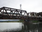 A southbound Amtrak crosses a railroad bridge over the Lewis River near Woodland on Thursday.