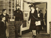 Mel Jackson, lower left, as an 8-year-old boy in 1943 greeting first lady Eleanor Roosevelt as she is escorted from the shipyard hospital.