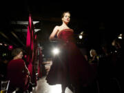 The crowd in the Atrium Lounge watches Catherine Rae's satin red dress on the runway.