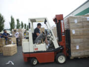 Mike Brackenbrough, who does inventory control for United Home Technologies, takes his dog, Cras, for a ride while he prepares product for shipping the company's Salmon Creek facility.