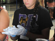 Lincoln: Lili Delgadillo learns proper hand-washing and equipment-sanitizing techniques during Washington Business Week's health care camp.