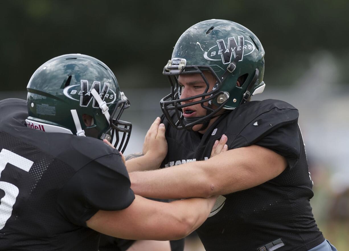 The bitter taste of Woodland's winless season in 2010 still lingers with lineman Zach Lacey, right, and other seniors on the Beavers football team.