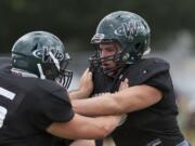 The bitter taste of Woodland's winless season in 2010 still lingers with lineman Zach Lacey, right, and other seniors on the Beavers football team.