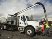 A City of Vancouver  crew uses a Vactor truck to clean storm drains on Mill Plain Boulevard.