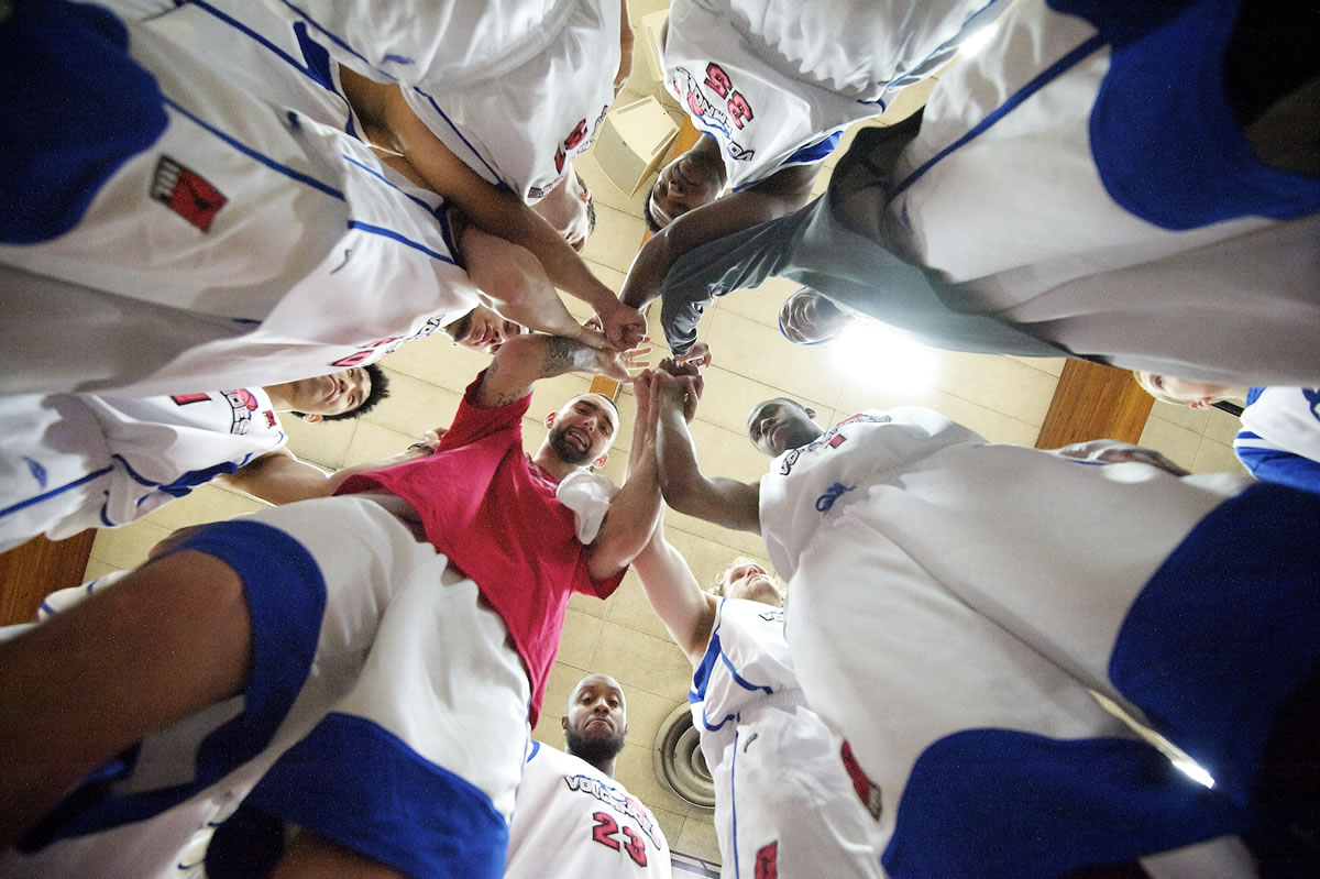 The Vancouver Volcanoes huddle after being introduced before their home opener on Sunday against the Bellingham Slam.