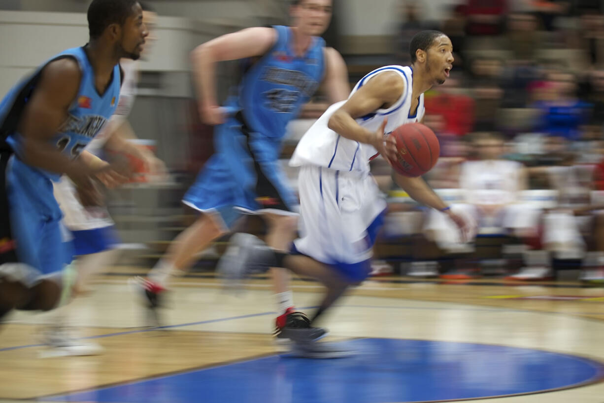 Vancouver Volcanoes' Josh Tarver drives up the court against the Bellingham Slam during the Volcanoes home opening game on Sunday at Clark College.