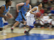 Vancouver Volcanoes' Josh Tarver drives up the court against the Bellingham Slam during the Volcanoes home opening game on Sunday at Clark College.