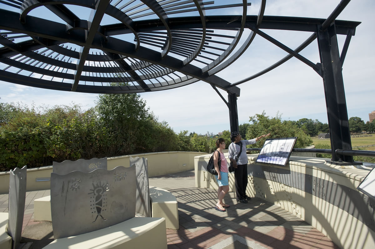 Beatrice Yoshioka, left, of Vancouver and Claudia Al-Amin of Portland stop during a stroll Wednesday on the Vancouver Land Bridge.