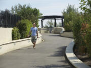 Cameron Van Blokland of Vancouver walks Wednesday along the Vancouver Land Bridge.