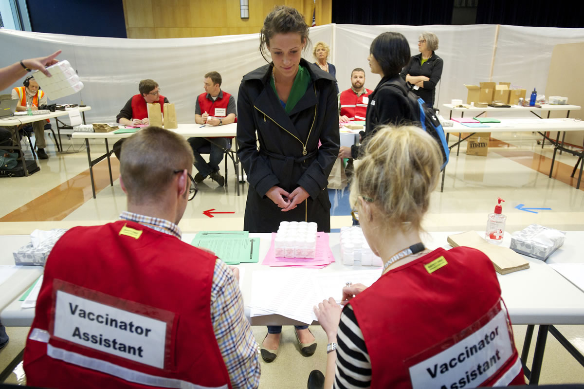 Jamie Bachaus with Clark County Public Health center, receives simulated medication during a bioterrorism exercise at Clark College's Gaiser Hall Thursday.