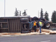 A lumber truck overturned on the ramp from state Highway 14 to Interstate 205 southbound Friday afternoon causing traffic in the area to backup.