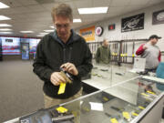 Vancouver resident Mark Havens shops for handguns at Brightwater Ventures Firearm Sales.