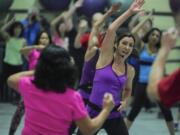 Jazzercise instructor Lisa Ackerman leads about 35 people through a class at LaCamas Swim &amp; Sport in Camas Wednesday.