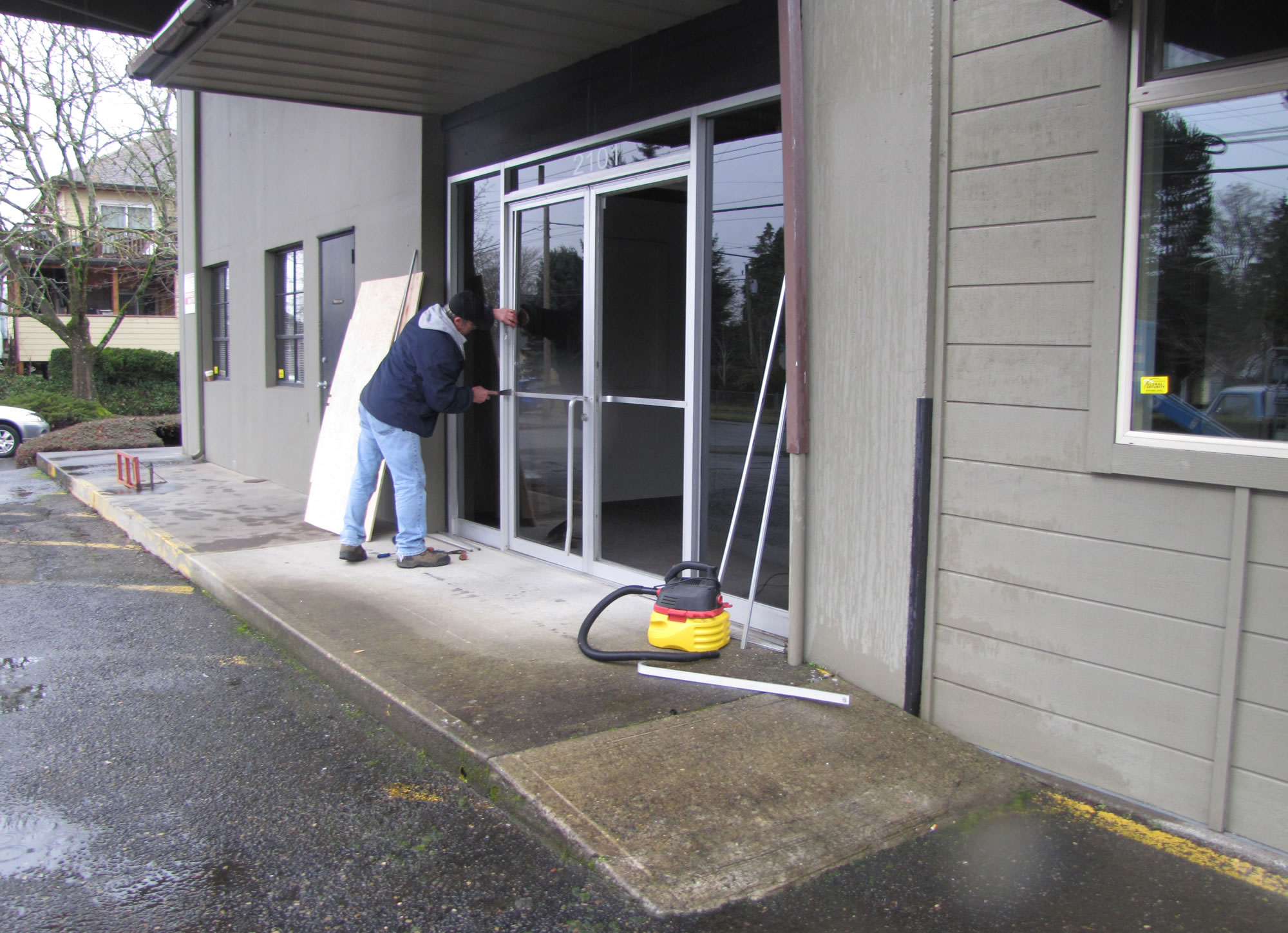 Kasey Norris with Vancouver Glass replaces glass doors at an office building where 16-year-old Douglas Combs was shot and killed by police Friday night.