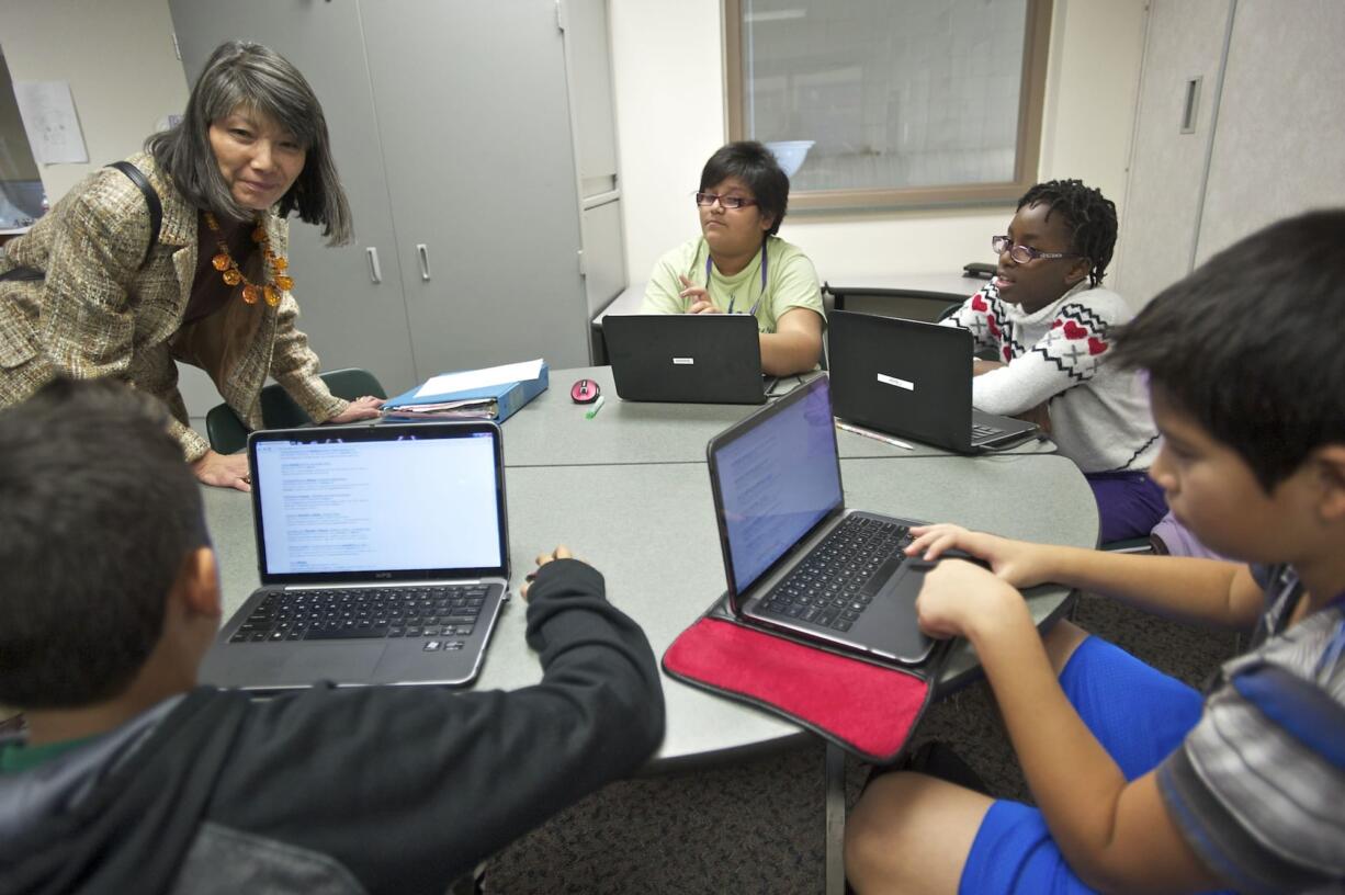 State Rep. Sharon Tamiko Santos, D-Seattle, chair of the House Education Committee, talks with students in a math class at Vancouver iTech Preparatory on Oct.