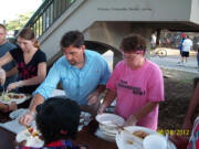 Shelley Rindahl
Chris Becker, left, and Shelley Rindahl serve up dinner for needy people under the Steel Bridge in Portland on Aug. 18.