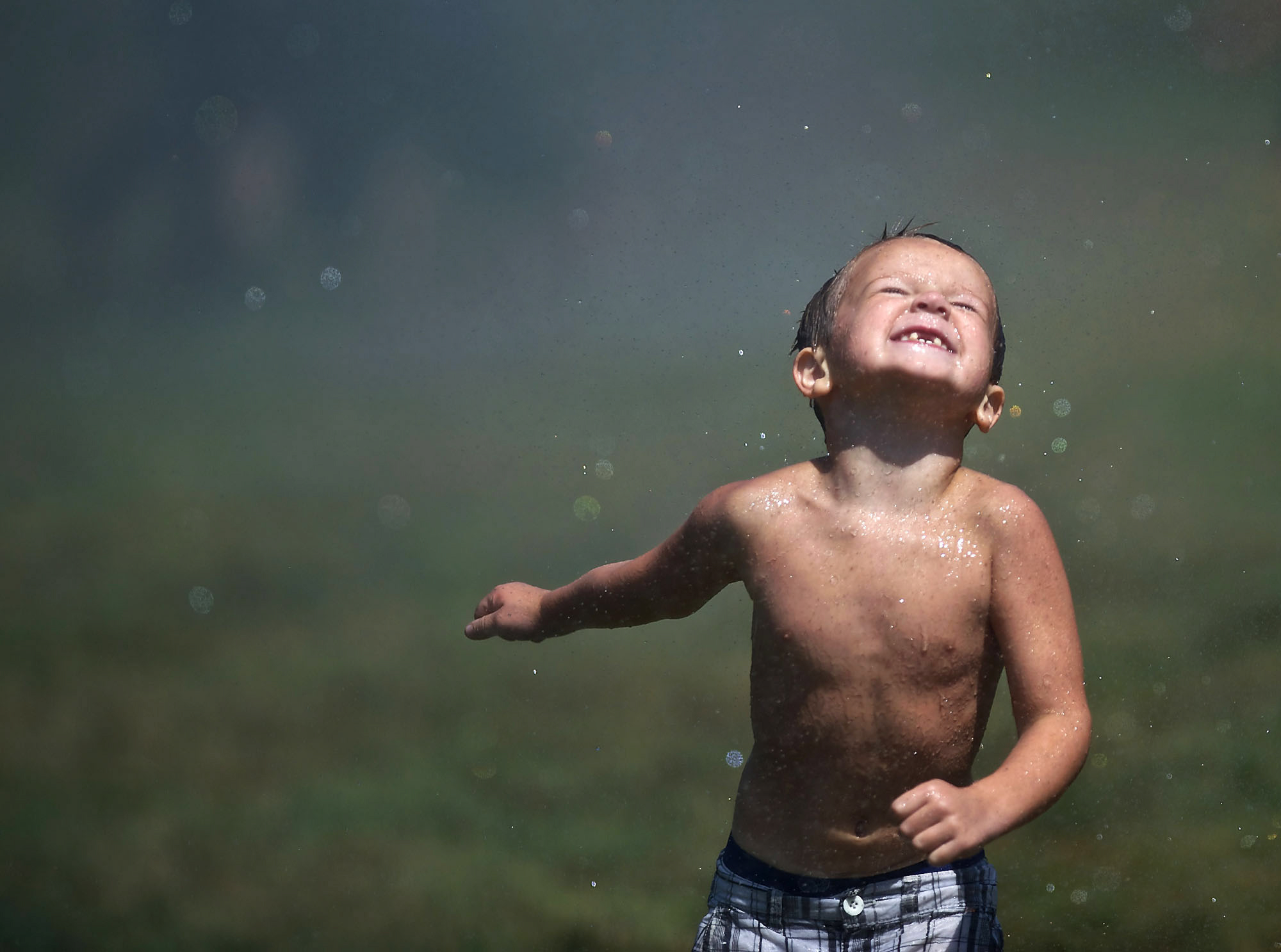 Tyler Huck enjoys a run through a stream of water after Camas-Washougal firefighters opened a fire hydrant at Hamlik Park in Washougal on Thursday to help kids beat the heat on a 100-degree day.