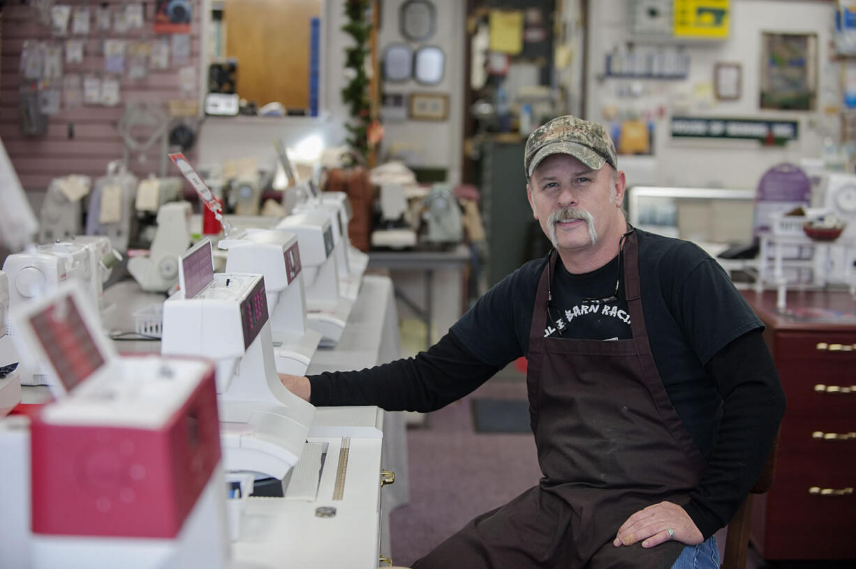 Gary Rael, general manager of House of Sewing Machines &amp; Vacuums, works at his shop in Hazel Dell last week.