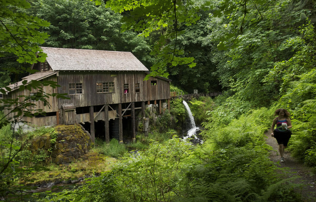 Photos by Steven Lane/The Columbian
The Cedar Creek Grist Mill was built in 1876 and restored in the 1980s. Water from the creek feeds a turbine underneath the center of the building.