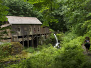 Photos by Steven Lane/The Columbian
The Cedar Creek Grist Mill was built in 1876 and restored in the 1980s. Water from the creek feeds a turbine underneath the center of the building.