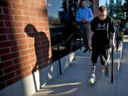 Justin Carey, who lost his leg after being struck by a car as he waited for the school bus, practices walking stairs Monday afternoon with his new prosthetic leg outside of Evergreen Prosthetics &amp; Orthotics.