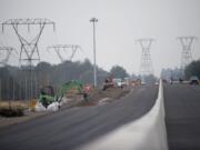 Crews are installing new concrete barriers as part of a $50 million project to widen state Highway 14 in Camas and Washougal.