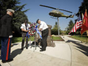 Marine Maj. Billy Canedo, left, takes part in a wreath ceremony Thursday with help from Jerry Keesee, right, commander of Southwest Washington's Richard L. Quatier Chapter of the Korean War Veterans Association, and Don Cohen, president of the Oregon Trail Chapter.