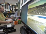 County traffic signal operations and engineering lead Rob Klug watches traffic flow and monitors traffic signal performance inside the Clark County Public Services building on Friday.