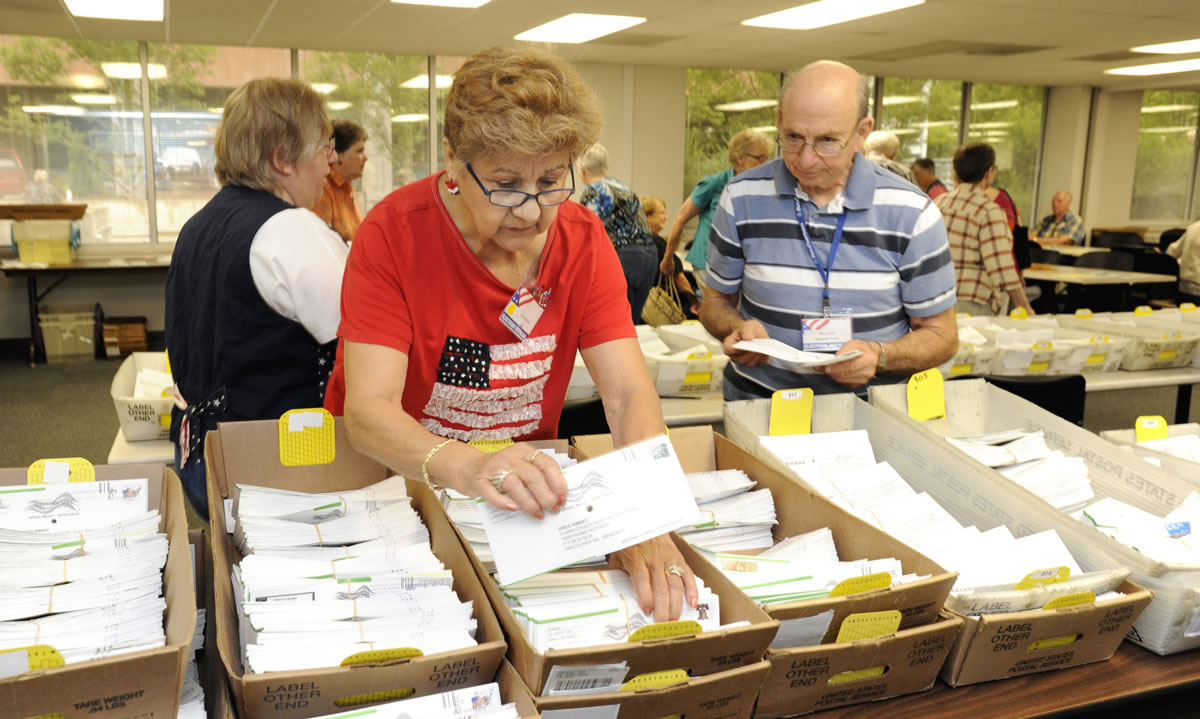 Elections officer Josie Karling, center, sorts ballots Tuesday at the Clark County Elections Office in Vancouver. The results are now in from Washington's top two primary election, and the general election is Nov.