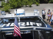 Clark County Sheriff's Deputy Kevin Gadaire explains to boaters the correct way to display their license on the side of their personal watercraft during a visit to the Marine Park boat launch Friday.