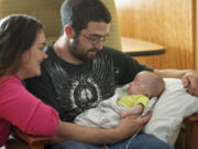 Tiffany Burril and Mitchall Gulliksen visit their daughter, Harley, in the neonatal intensive care unit at Legacy Salmon Creek Medical Center Thursday. Harley was born prematurely at 27 weeks gestation.