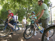 Michael Newton, from left, Todd Bachmann, James Cole, Saeed Hajarizadeh and Craig Lyons take part in a critical mass ride Friday, held to nudge the Port of Vancouver and the city about creating good bike and pedestrian access on Northwest Lower River Road.