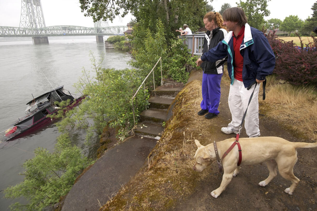 Richard Beechler, right, and Martha Brightwell, along with their 2-year-old pit bull, Cookie, used a 25-foot boat as a residence until May 6, when the boat hit some rocks and partially sank.