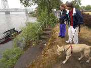 Richard Beechler, right, and Martha Brightwell, along with their 2-year-old pit bull, Cookie, used a 25-foot boat as a residence until May 6, when the boat hit some rocks and partially sank.