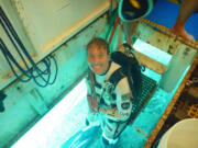 Dottie Metcalf-Lindenburger suits up before a trip outside the Aquarius underwater habitat.