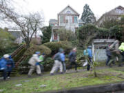 The 50+ Forever Young Hikers, a Vancouver Parks and Recreation group, attack the sloping streets of Northwest Portland as they head for Forest Park and Pittock Mansion on a Tuesday morning in December.