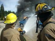 East County: A volunteer practices extinguishing a vehicle fire during East County Fire &amp; Rescue's annual Citizens' Basic Fire and EMS Academy on June 22 at the Fern Prairie Fire Station, north of Camas.