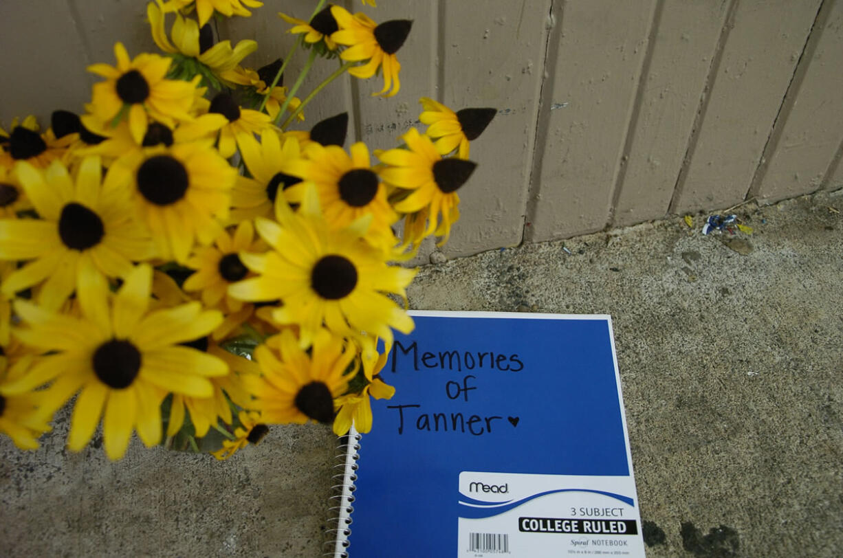 Students set up a memorial for the victim of Wednesday night's fatal crash, 17-year-old Tanner Trosko, at Ridgefield Pioneer Marketplace.