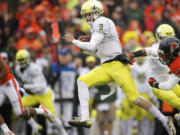 Oregon's Marcus Mariota picks up a first down Oregon State on Saturday at Reser Stadium in Corvallis.