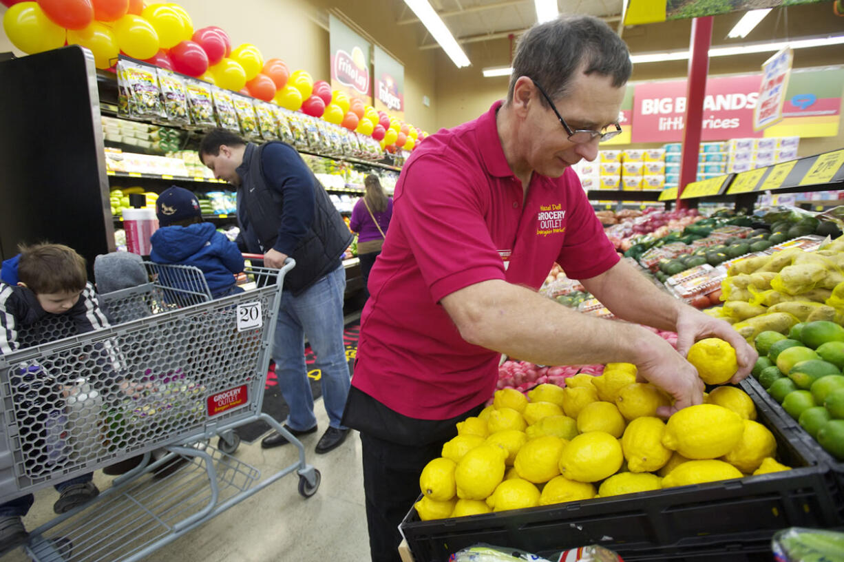 Photos by Steven Lane/The Columbian
Doug Martinson, produce manager of the Grocery Outlet in Hazel Dell, arranges lemons during the new store's &quot;soft opening&quot; Thursday. The official opening is Saturday.