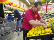 Photos by Steven Lane/The Columbian
Doug Martinson, produce manager of the Grocery Outlet in Hazel Dell, arranges lemons during the new store's &quot;soft opening&quot; Thursday. The official opening is Saturday.