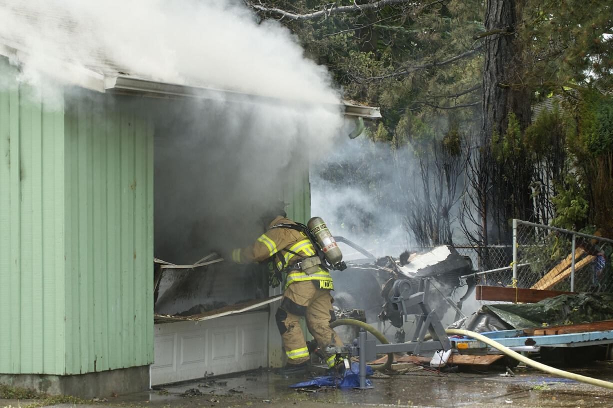 Firefighters with Fire District 6 control a house fire at 815 N.W.