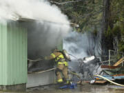 Firefighters with Fire District 6 control a house fire at 815 N.W.