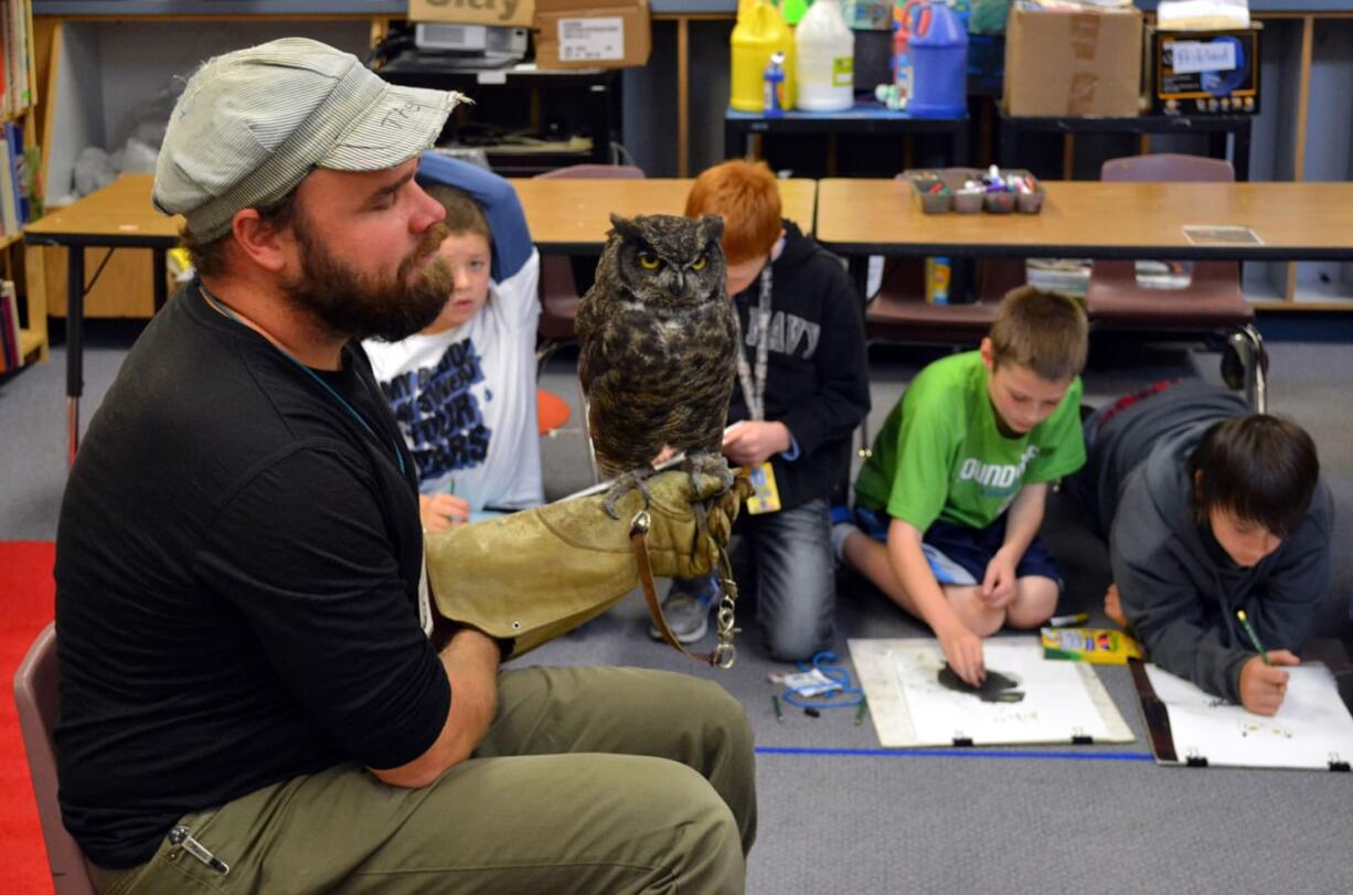 Ridgefield: Audubon Society of Portland environmental educator Tim Donner shows an owl named Julio to fifth-grade art students at Union Ridge Elementary on Oct. 25.